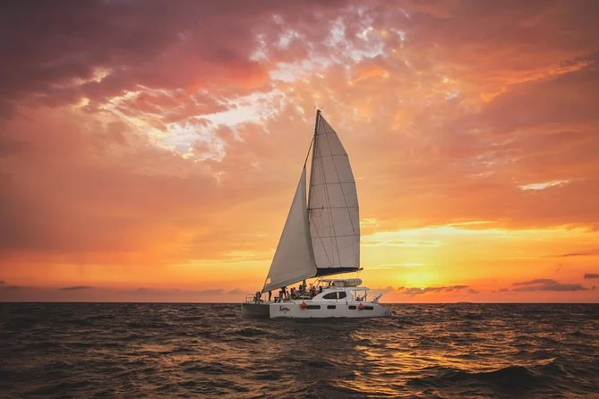 A sailboat under sail at sunset on Banderas Bay