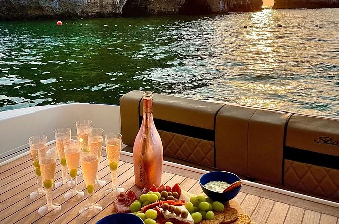 Champagne glasses and a fruit platter on a yacht deck